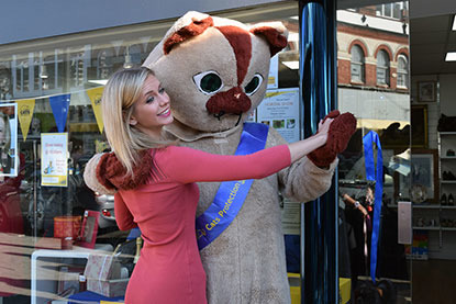 Rachel Riley with cat mascot outside Cats Protection shop
